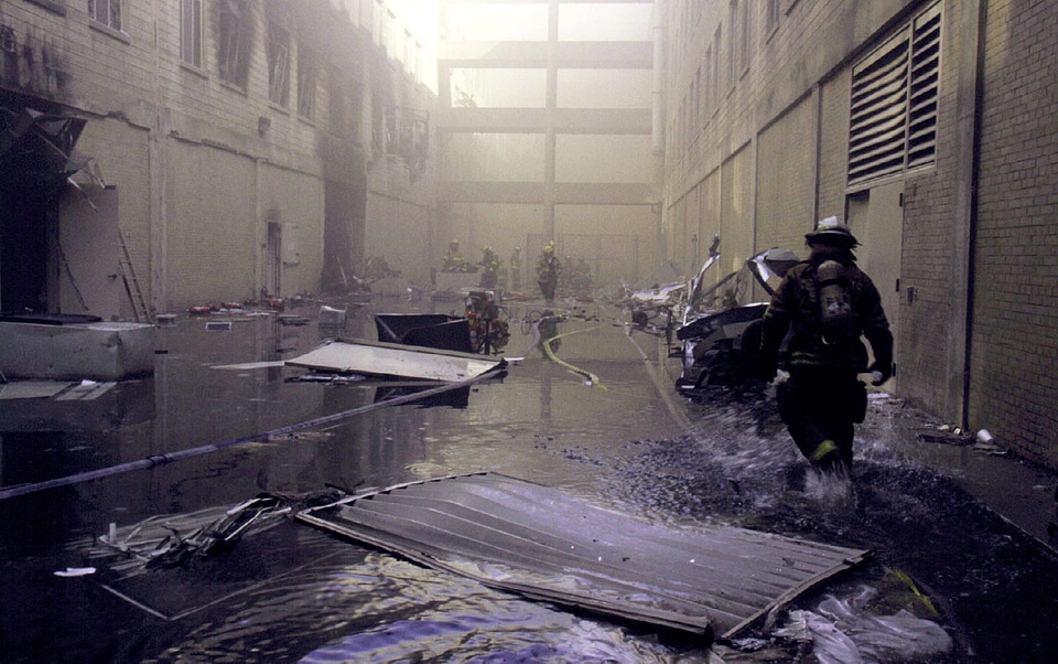 A fire fighter makes his way towards the fire on the second day