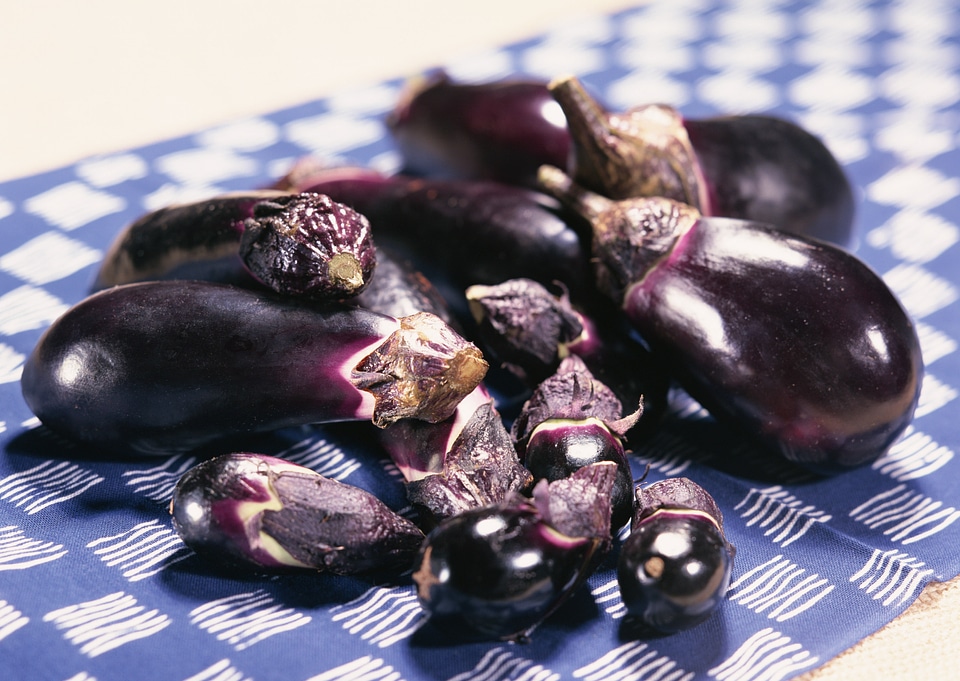 Vibrant fresh aubergine on tablecloth