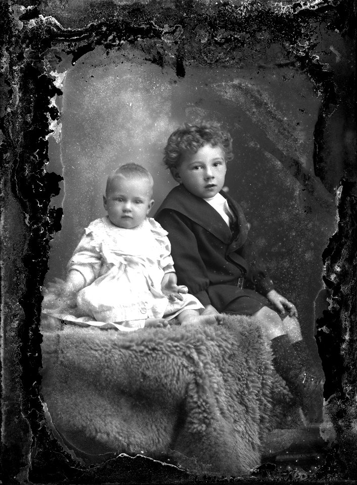 Two young brothers seated on a fleece,, m.d.