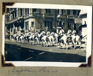 Mounted Egyptian Police passing a sign saying "H.B.M.'s and Imperial Forces. Music for all ranks"