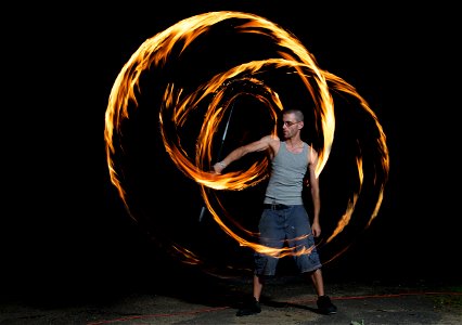 Ray spinning a fire staff photo