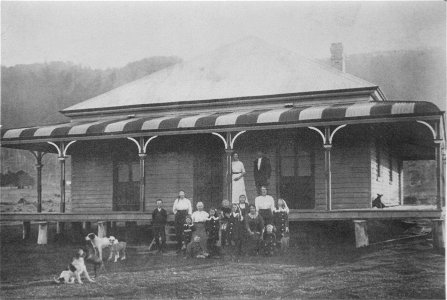 Family and dogs outside their rural home, [n.d.] photo