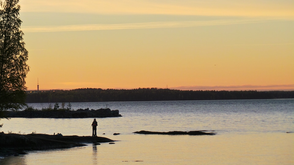 Fishing spinning at sunset. Silhouette of a fisherman