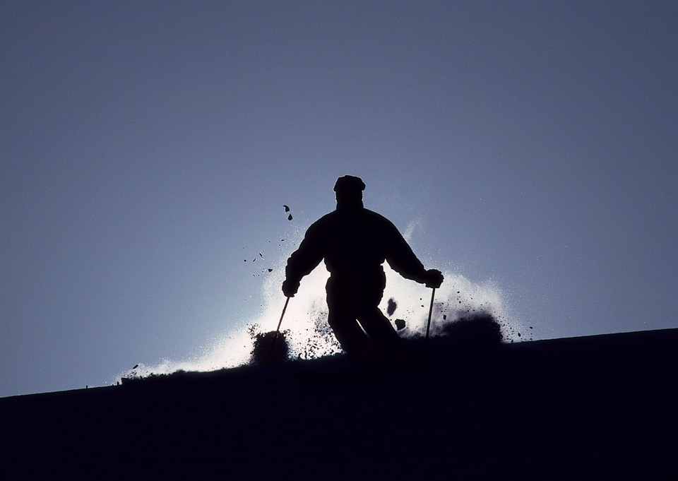 Skier on a slope at sunset