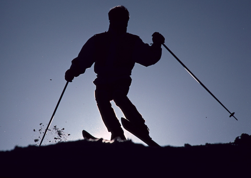 Skier on a slope at sunset