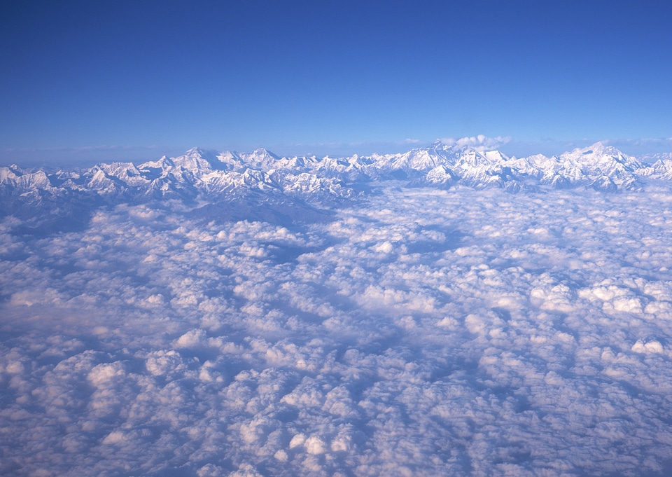 alpine landscape with peaks covered by snow and clouds