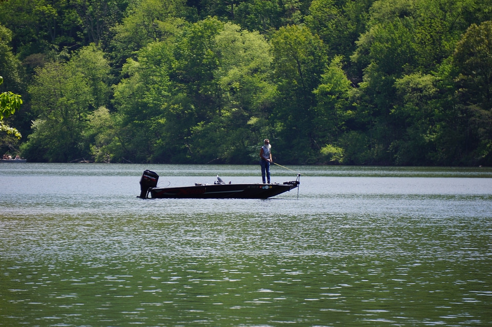 fisherman in a boat floating on the river