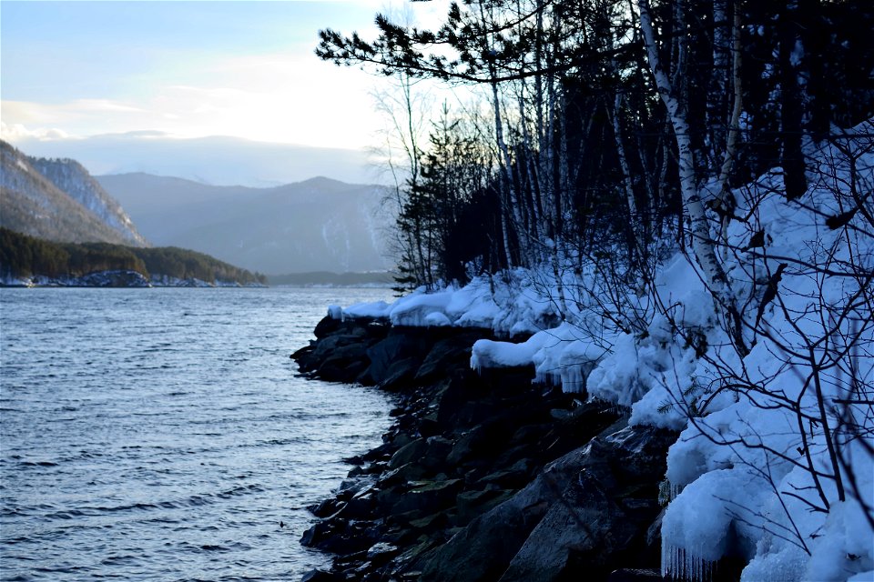 winter road along the river and mountains photo