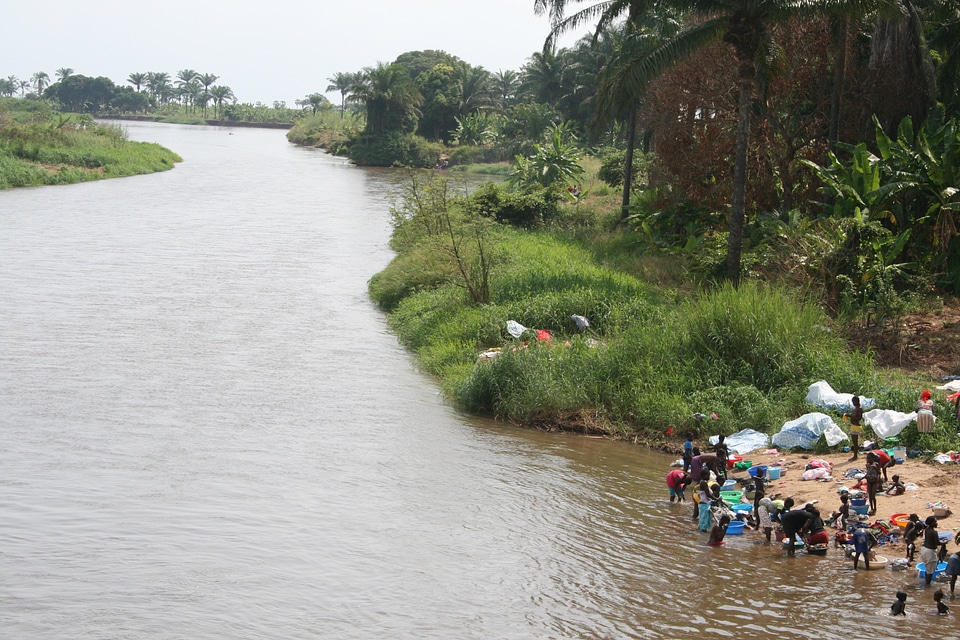 People washing clothes near a river in Angola