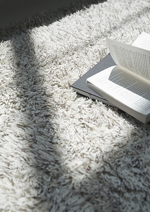 Book on shaggy carpet. Top view. photo