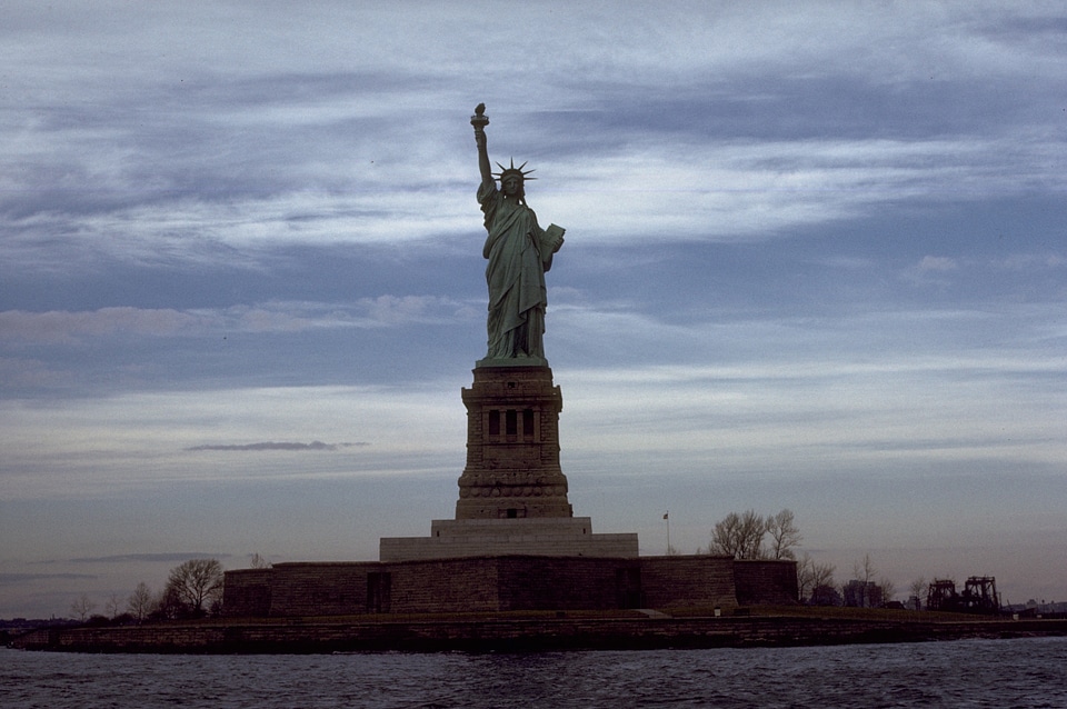 The Statue Of Liberty Monument On Liberty Island At Dusk