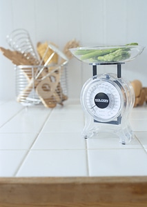 Fresh veggies on kitchen scale photo