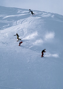 Alpine skier skiing downhill photo