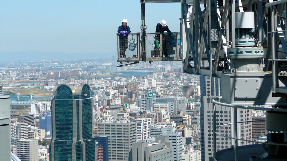 builder worker in safety protective equipment installing