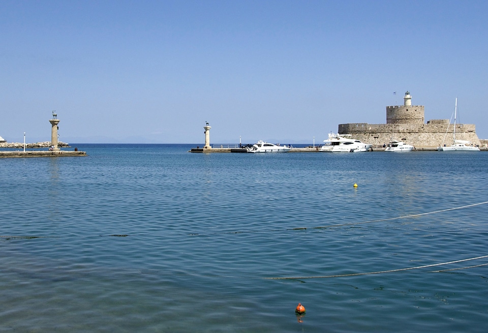 Panorama of Mandraki harbor and bronze deer statues
