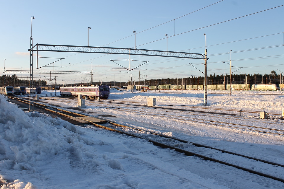 A train is arriving on a snow covered train station in the winter