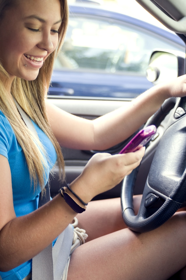 A Teen Girl Texting While Driving