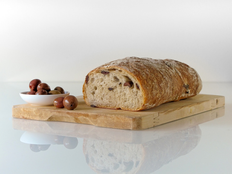 freshly baked ciabatta bread on wooden cutting board