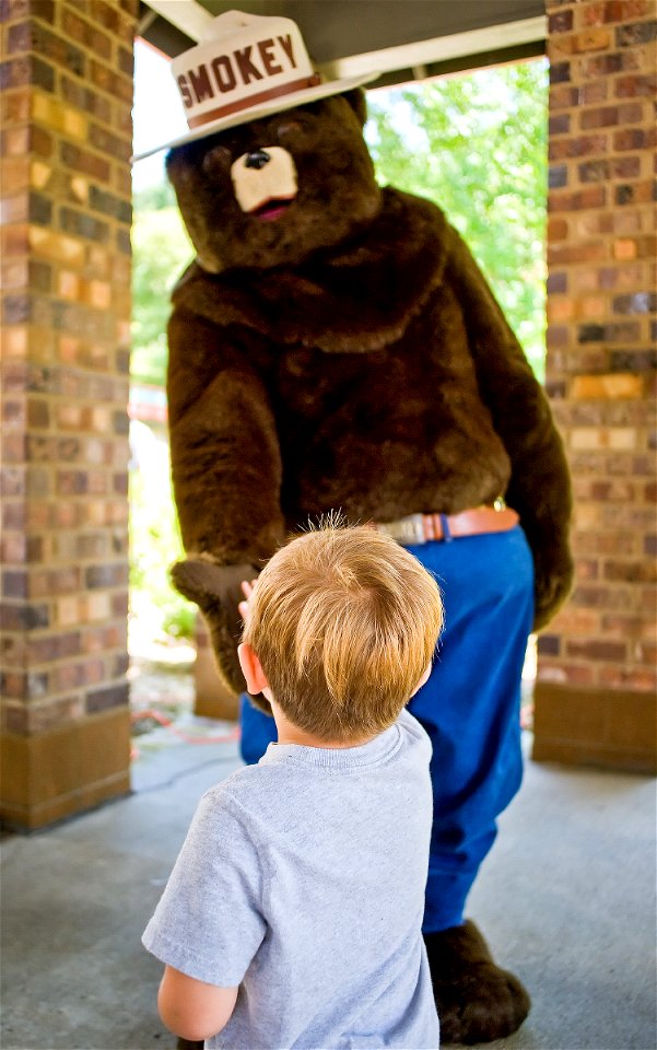 Smokey Bear High-Fiving a Kid