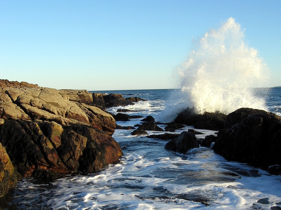 A wave crashes into the rocks at Ship Harbor