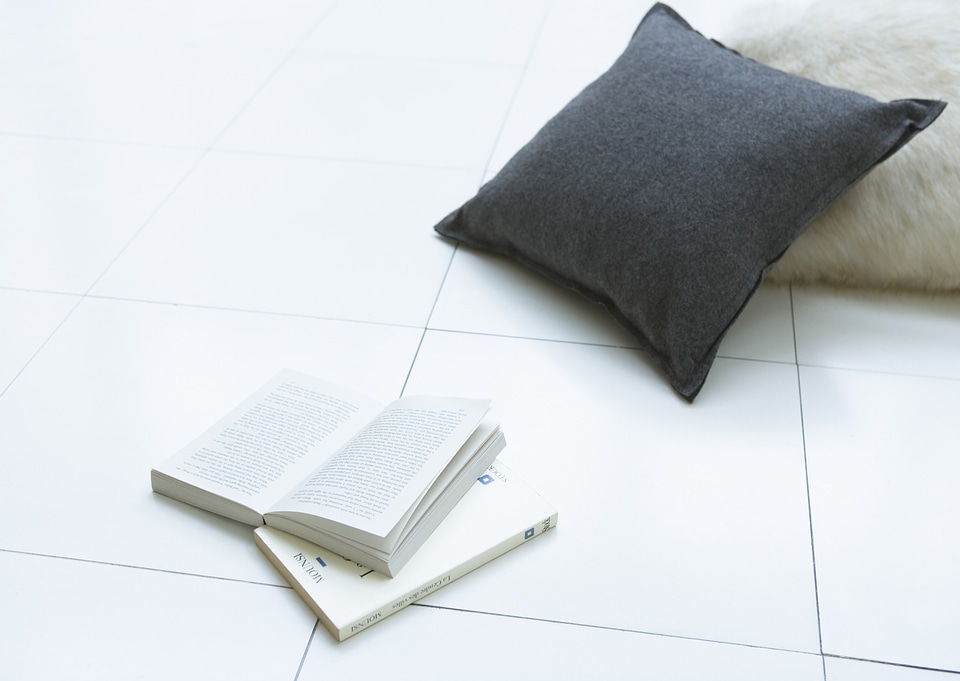 Pillows on floor with book