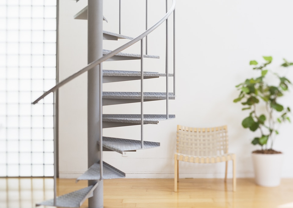 modern white staircase with wooden floor and glass barrier