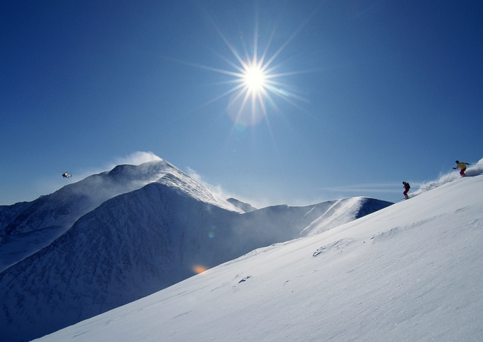 Full length of skier skiing on fresh powder snow