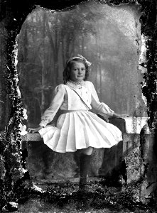 Girl seated on rail, n.d.