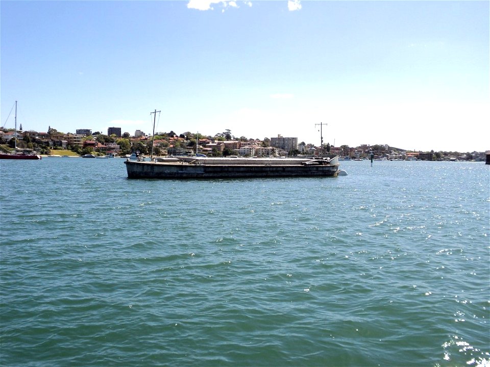 RAN Armament Depot Spectacle Island - 100-ton concrete ammunition lighter #CAL10014 on swing mooring adjacent to Spectacle Island.