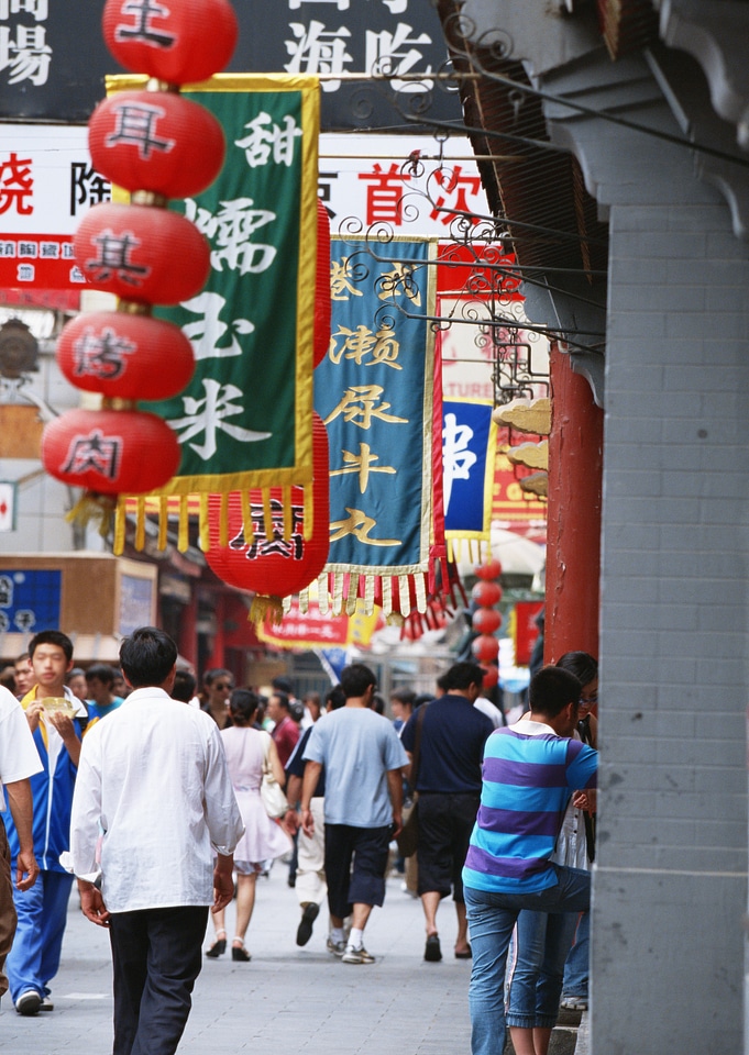 Busy back street filled with people near Chien Men