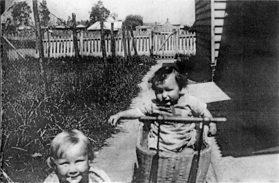 Toddler and baby in the back yard, [n.d.] photo