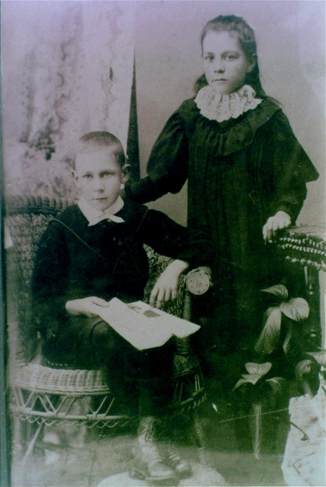 Studio portrait of a boy and girl, [n.d.] photo