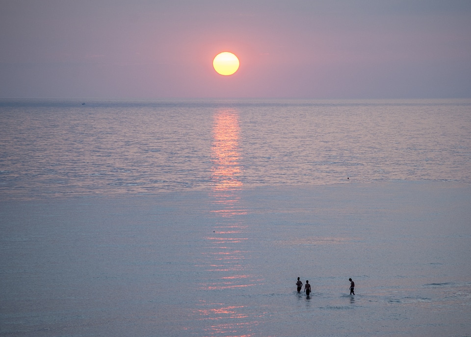 People on the beach at sunrise