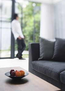 Fresh fruits on table in living room with a man photo