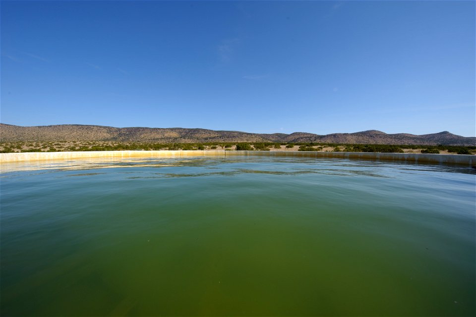 Mountains fill the horizon over this water storage facility in West Texas.