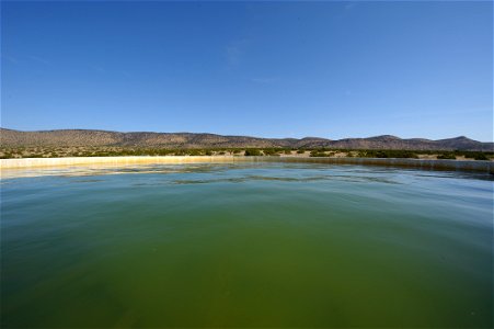 Mountains fill the horizon over this water storage facility in West Texas. photo
