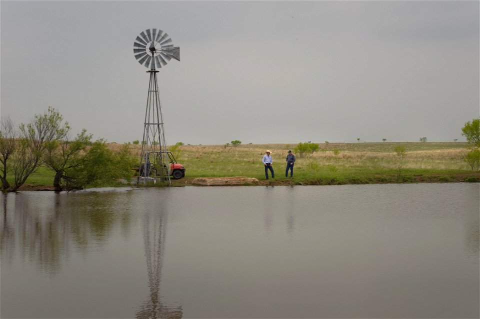 stockpond with windmill and rancher with NRCS