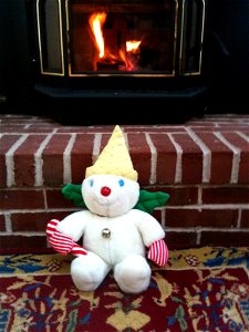 Mr. Bingle in front of a fireplace