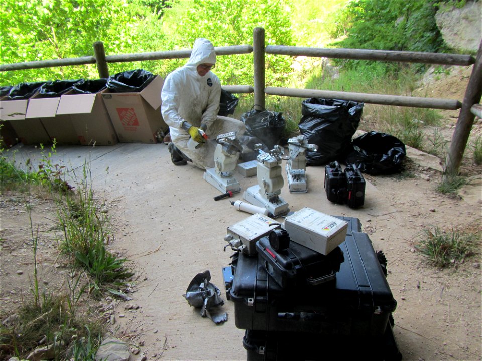Researcher handling equipment from cave