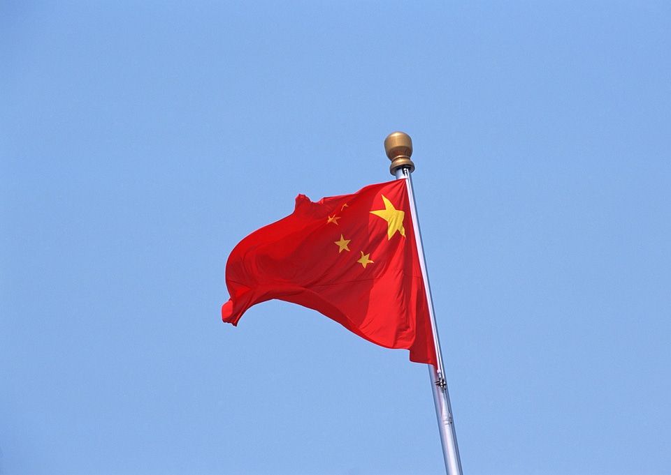 Chinese flag against a blue sky