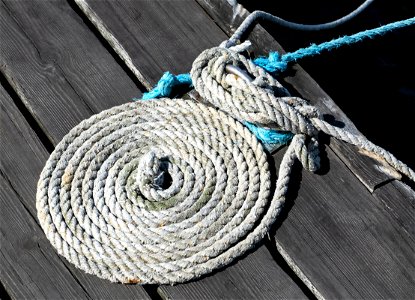 Coiled white mooring rope photo