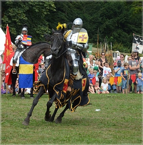 Knight with lance riding on horseback photo