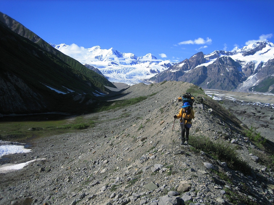 Backpacker crossing glacial moraine