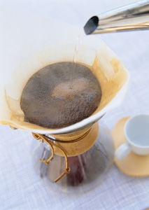 Making brewed arabica coffee from steaming filter drip style photo