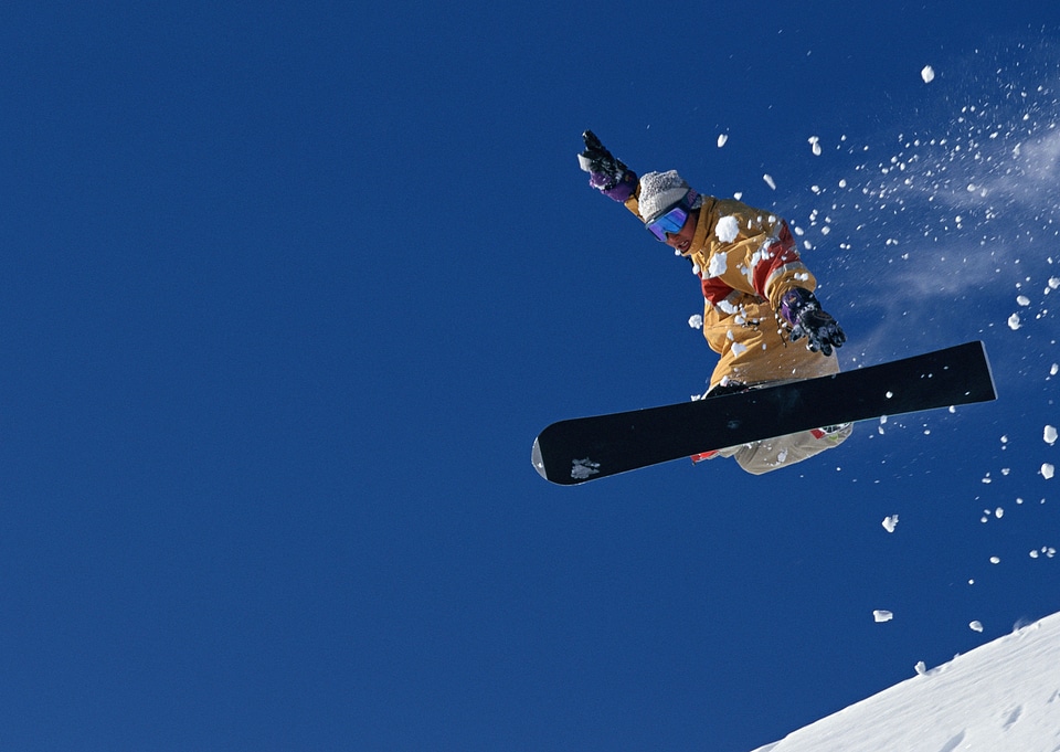 Snowboarder in high mountains during sunny day