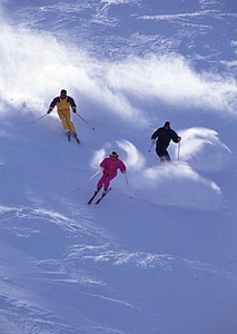 Alpine skier skiing downhill photo