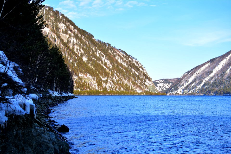 winter road along the river and mountains photo