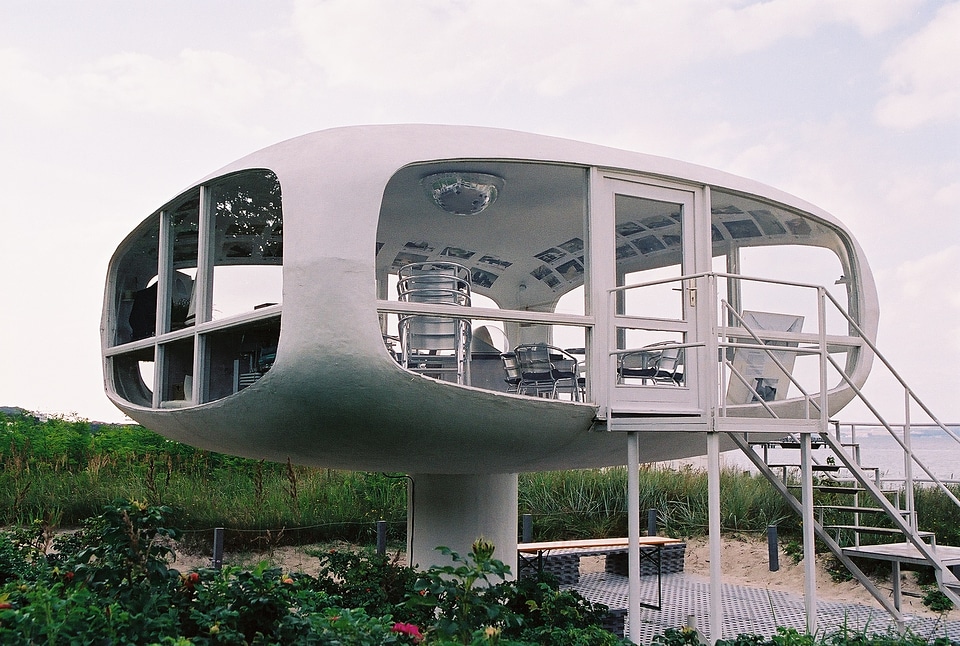 a very modern white house on the beach