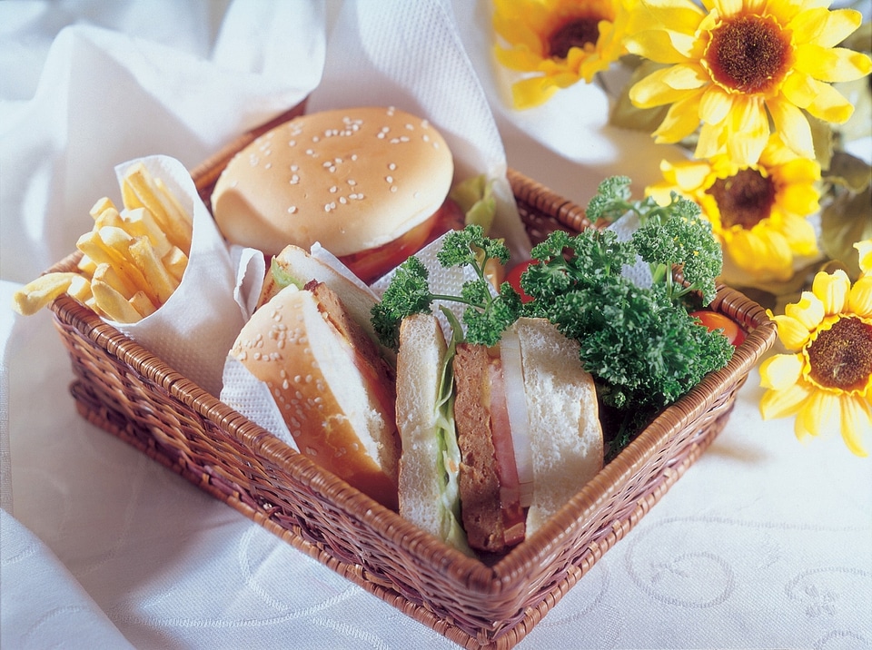 a cheeseburger with deep fried potatoes, closeup