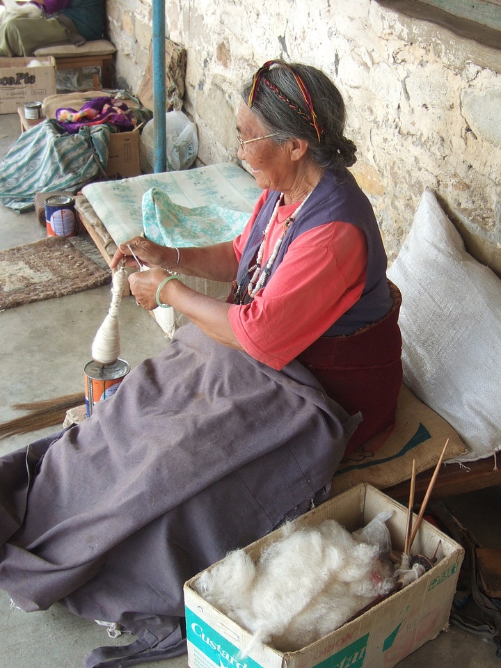 Tibetan woman spinning wool in Nepal